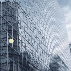 modern glass building under the blue sky with brilliant rays